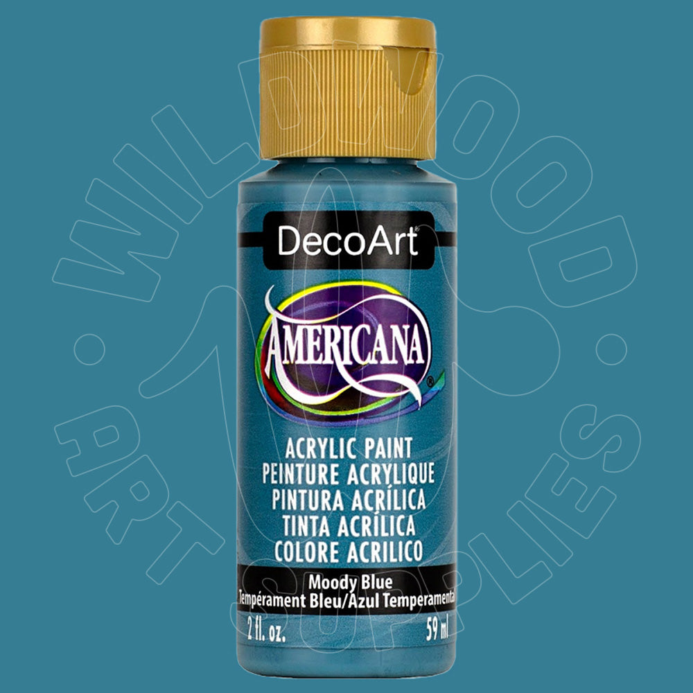 A bottle of DecoArt Americana acrylic paint in the color 'Moody Blue', featuring a metallic blue label and a gold cap, set against a solid teal-blue background with a faint watermark.
