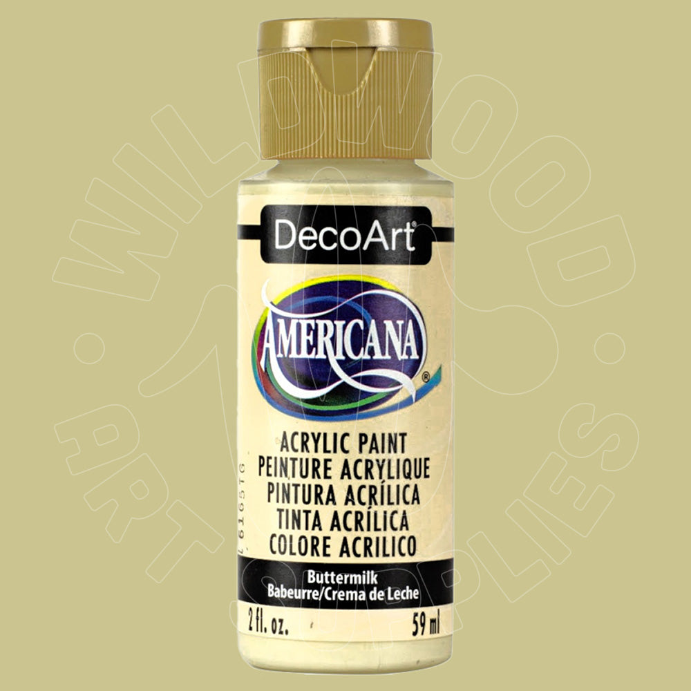 A bottle of DecoArt Americana acrylic paint in the shade Buttermilk, featuring a gold cap and cream-colored label on a solid light olive-green background.