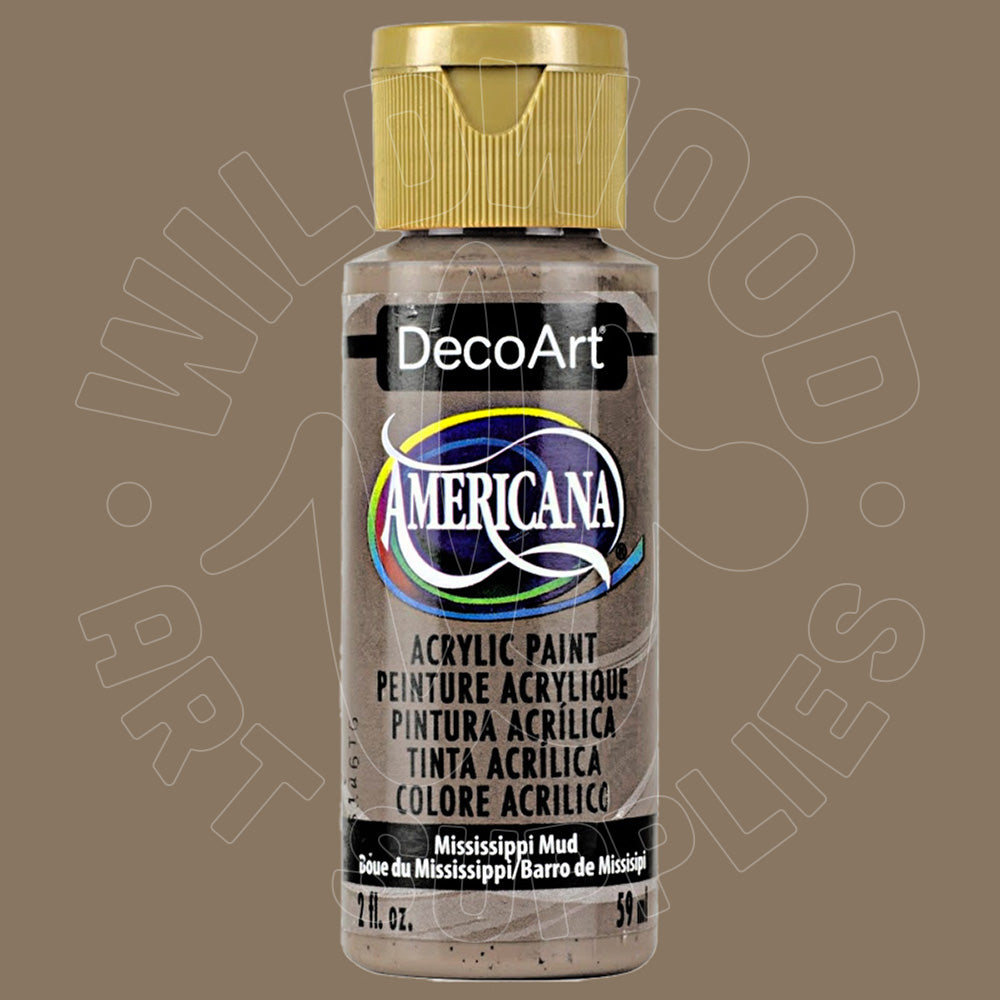 A bottle of DecoArt Americana acrylic paint in the color 'Mississippi Mud' (barre de Missisipi), featuring a gold cap and a clear bottle showing the gray-brown paint inside, set against a solid taupe background.