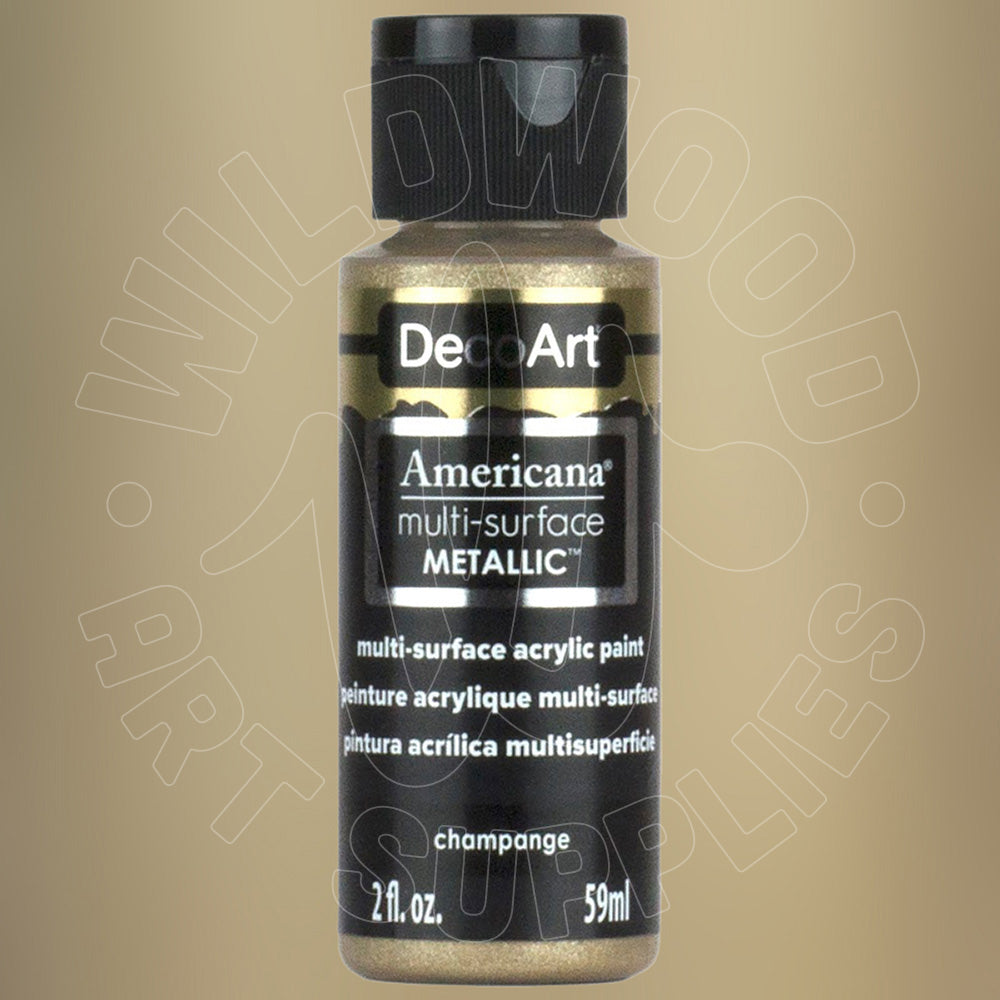 A bottle of DecoArt Americana multi-surface Metallic acrylic paint in the shade 'champagne', featuring a black cap and black label with gold glitter paint visible through the clear bottle, set against a solid beige background.