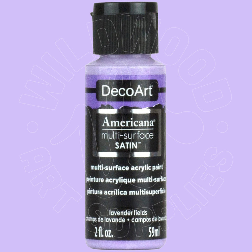 A bottle of DecoArt Americana multi-surface satin acrylic paint in the color 'lavender fields', featuring a lavender-purple label and a black cap, set against a solid lavender background.