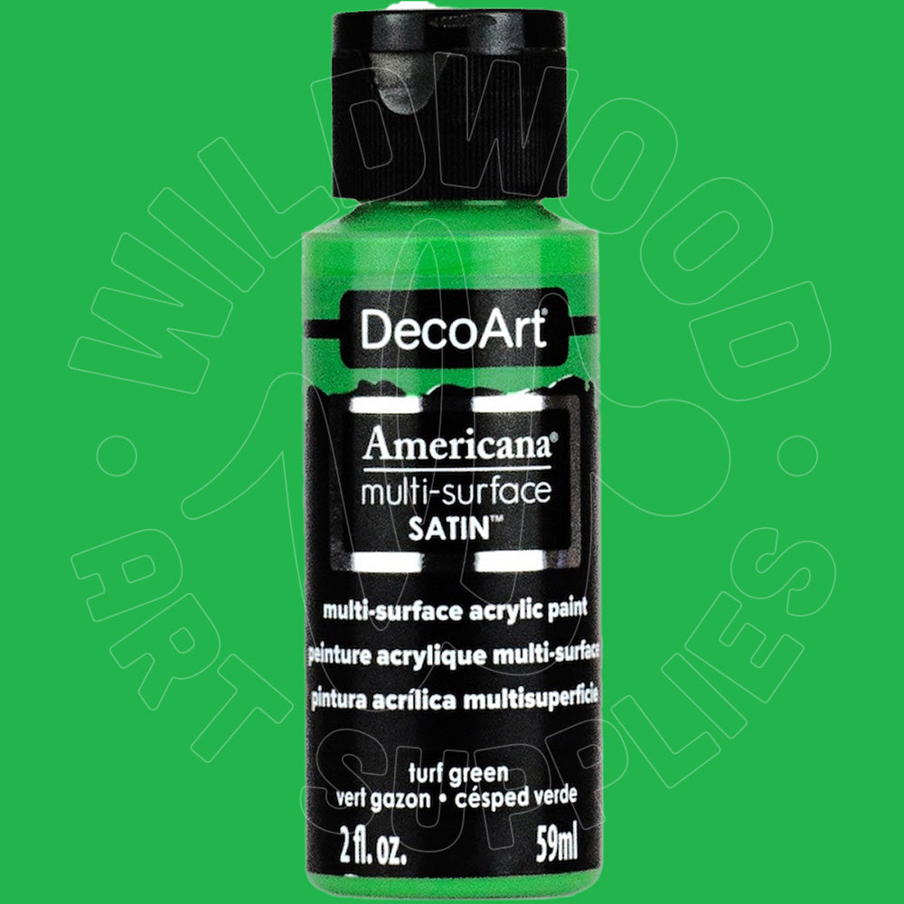 A bottle of DecoArt Americana multi-surface satin acrylic paint in turf green, shown against a solid green background with a faint watermark.