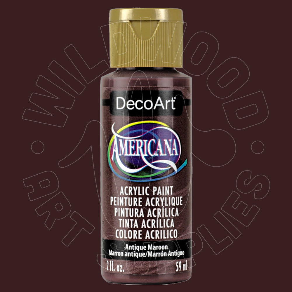 A bottle of DecoArt Americana acrylic paint in the color 'Antique Maroon' (Marrón antiguo), featuring a gold cap and a black label with a purple and blue logo, set against a dark maroon background with a faint watermark.