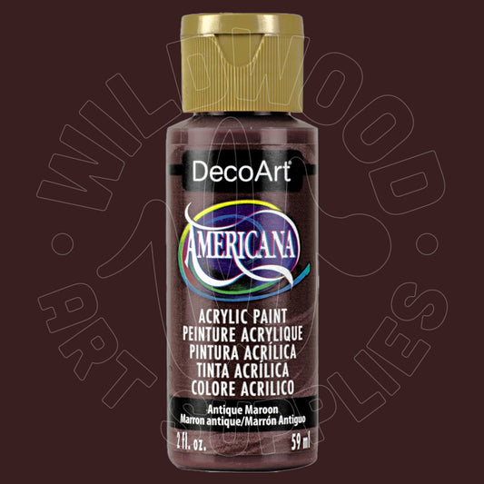A bottle of DecoArt Americana acrylic paint in the color 'Antique Maroon' (Marrón antiguo), featuring a gold cap and a black label with a purple and blue logo, set against a dark maroon background with a faint watermark.