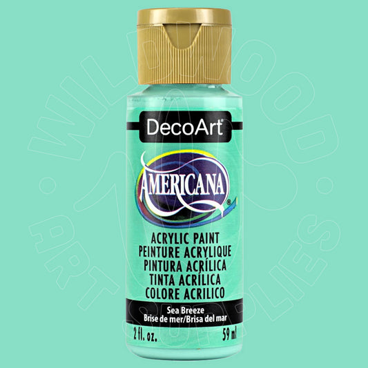 A bottle of DecoArt Americana acrylic paint in the color 'Sea Breeze', featuring a light aqua/mint green label and a gold cap, set against a solid mint green background.