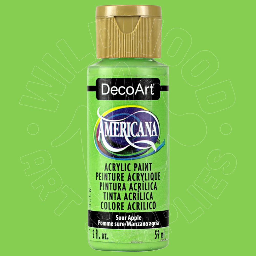 A bottle of DecoArt Americana acrylic paint in Sour Apple, featuring a bright lime green paint visible through the clear bottle, a gold cap, and a black label with the DecoArt and Americana branding.