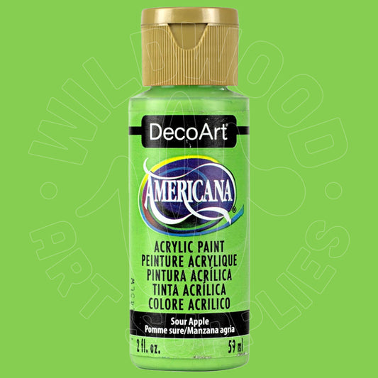 A bottle of DecoArt Americana acrylic paint in Sour Apple, featuring a bright lime green paint visible through the clear bottle, a gold cap, and a black label with the DecoArt and Americana branding.