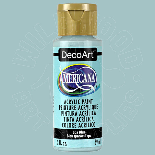A bottle of DecoArt Americana acrylic paint in the color 'Spa Blue', featuring a light blue label and a gold cap, set against a solid light blue-gray background with a faint watermark.