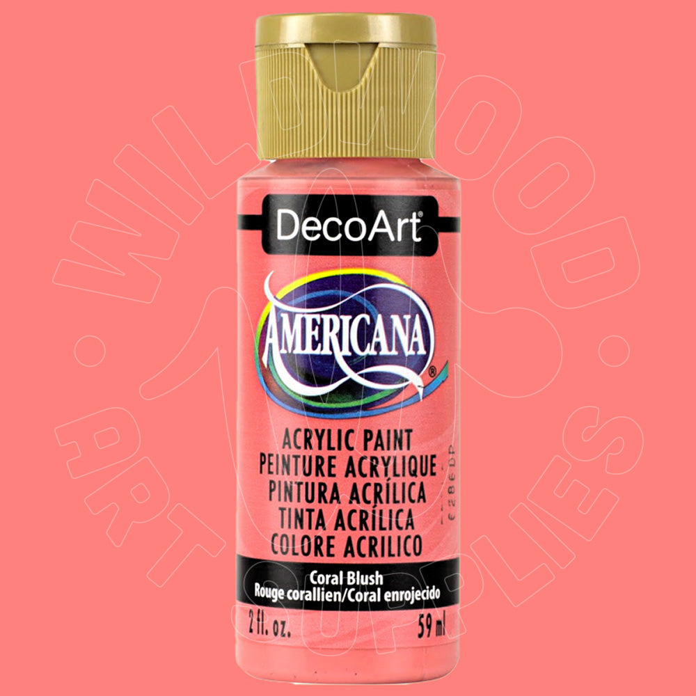 A bottle of DecoArt Americana acrylic paint in the shade Coral Blush, featuring a pink body, gold cap, and a black label with white and blue branding.