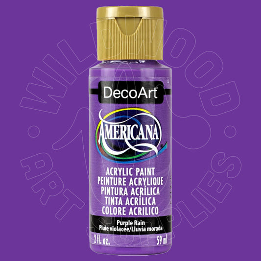 A bottle of DecoArt Americana acrylic paint in the shade 'Purple Rain' against a solid purple background. The bottle is purple with a gold cap, and features a black label with white text.