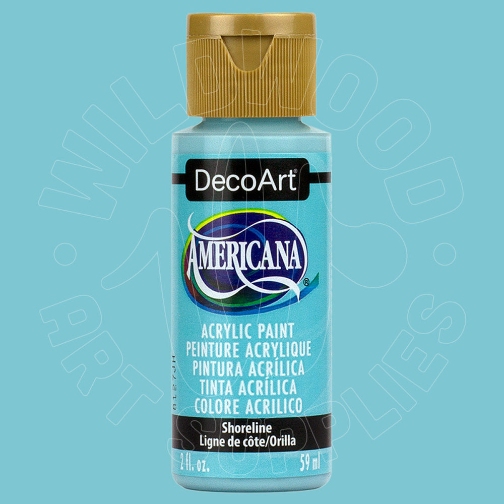 A bottle of DecoArt Americana acrylic paint in the Shoreline color, featuring a light blue label and a metallic gold cap, set against a solid light blue background.