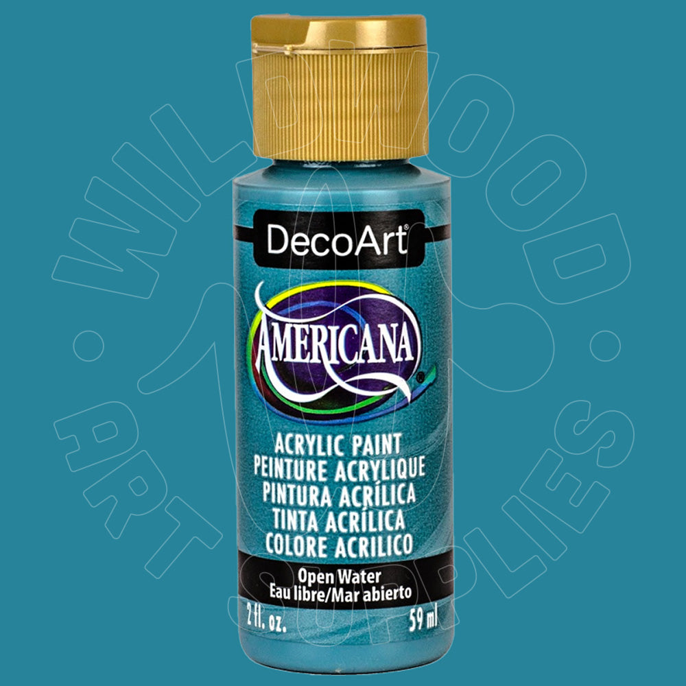 A bottle of DecoArt Americana acrylic paint in the shade Blue Water, featuring a metallic teal-blue label and a gold cap, set against a solid teal-blue background with a faint watermark.