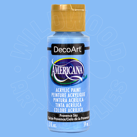 A bottle of DecoArt Americana acrylic paint in the color 'Provence Sky' (a light sky blue), featuring a gold cap and a blue label, set against a solid light blue background.