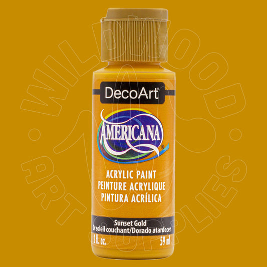 A bottle of DecoArt Americana acrylic paint in the color Sunset Gold, shown against a solid mustard yellow background with a faint watermark.