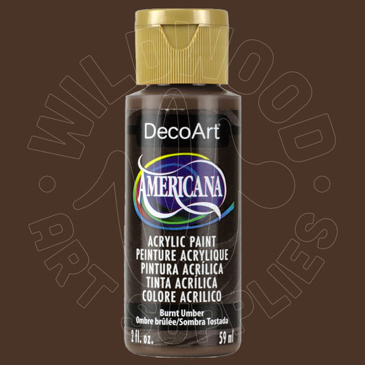 A bottle of DecoArt Americana acrylic paint in the color Burnt Umber, featuring a gold cap and a black label with white text, set against a dark brown background with a faint watermark.
