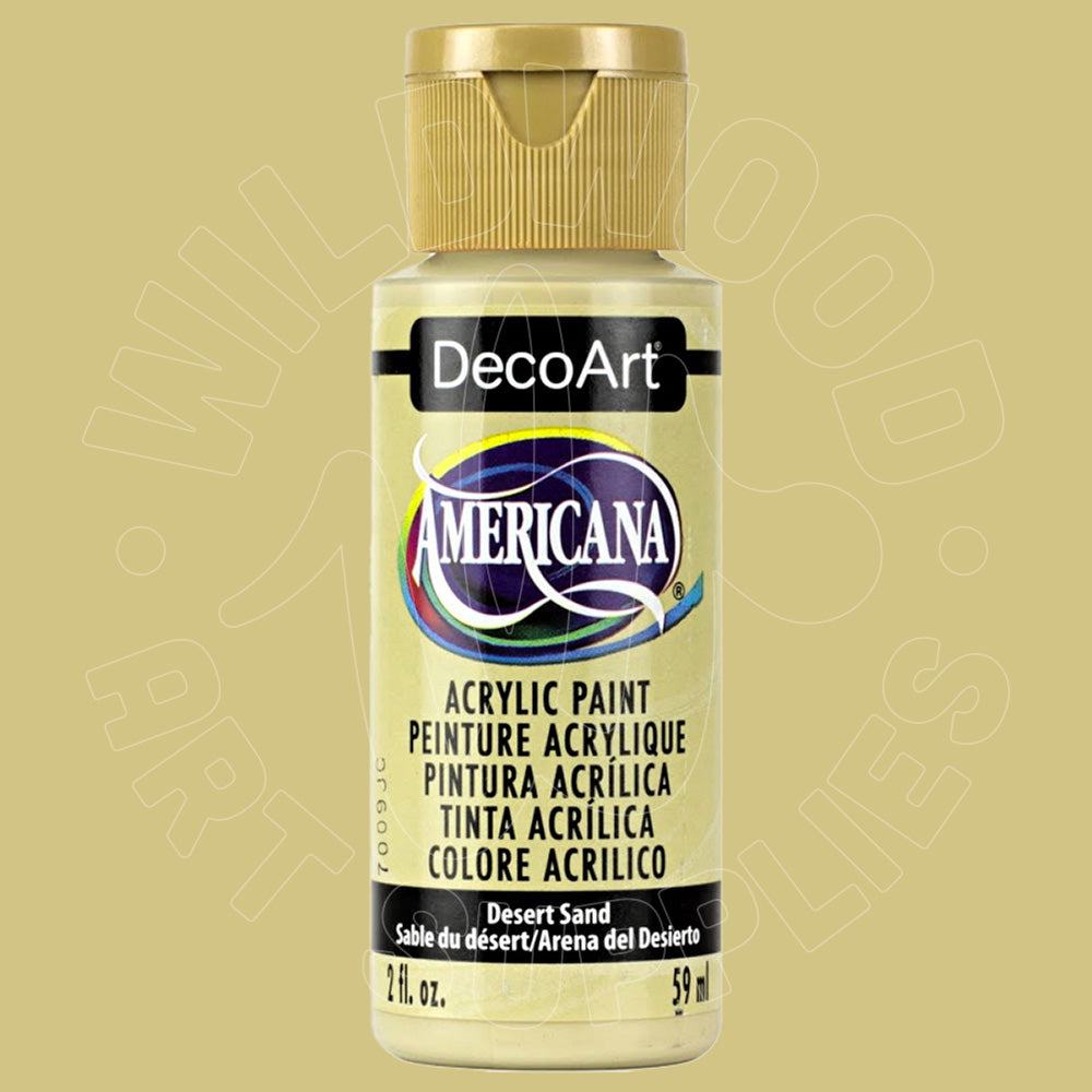 A bottle of DecoArt Americana acrylic paint in the color 'Desert Sand' (Beige), featuring a gold cap and a cream-colored label with black text.
