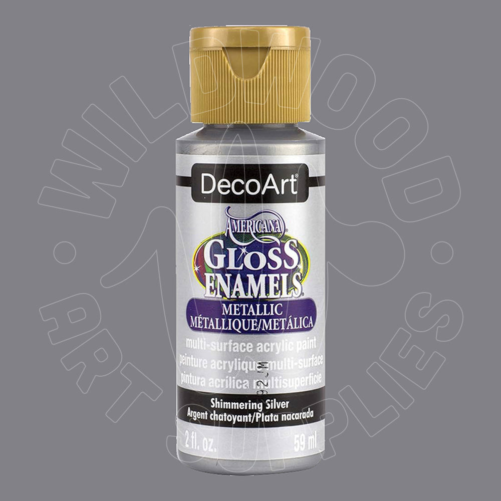 A bottle of DecoArt Metallic Enamel Acrylic Paint in Shimmering Silver, featuring a gold cap and a silver label with purple and gold accents, set against a solid gray background.