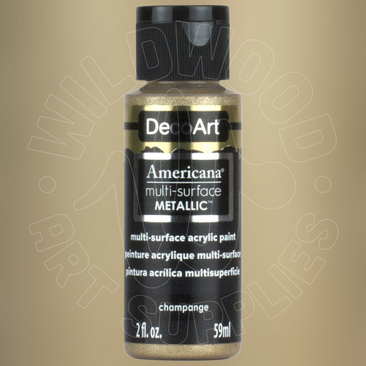 A bottle of DecoArt Americana multi-surface Metallic acrylic paint in the shade 'champagne', featuring a black cap and black label with gold glitter paint visible through the clear bottle, set against a solid beige background.