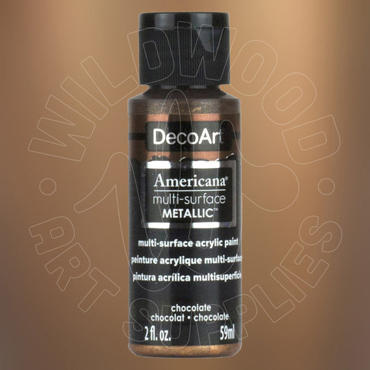 A bottle of DecoArt Americana multi-surface metallic acrylic paint in the shade 'Chocolate', featuring a black cap and black label with gold glittery text, set against a warm brown gradient background with a faint watermark.