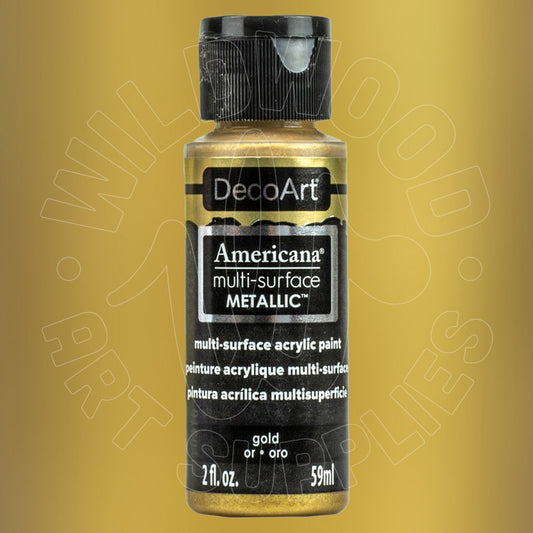 A bottle of DecoArt Americana multi-surface Metallic acrylic paint in gold, featuring a black cap and black label with white text, set against a textured gold background.