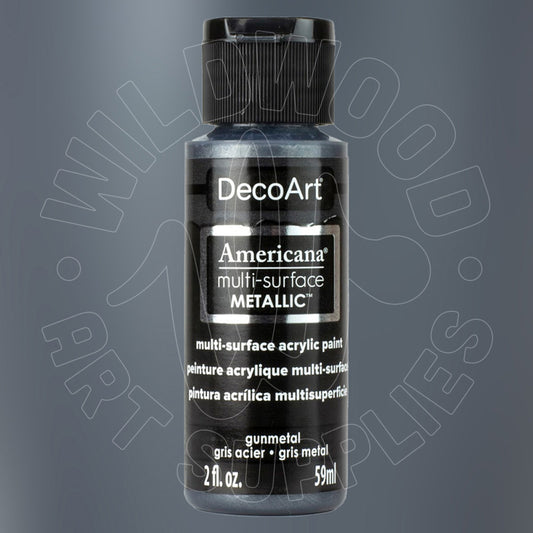 A bottle of DecoArt Americana Multi-Surface Metallic acrylic paint in gunmetal gray, featuring a black cap and a black label with white text, set against a dark gray gradient background with a faint watermark.