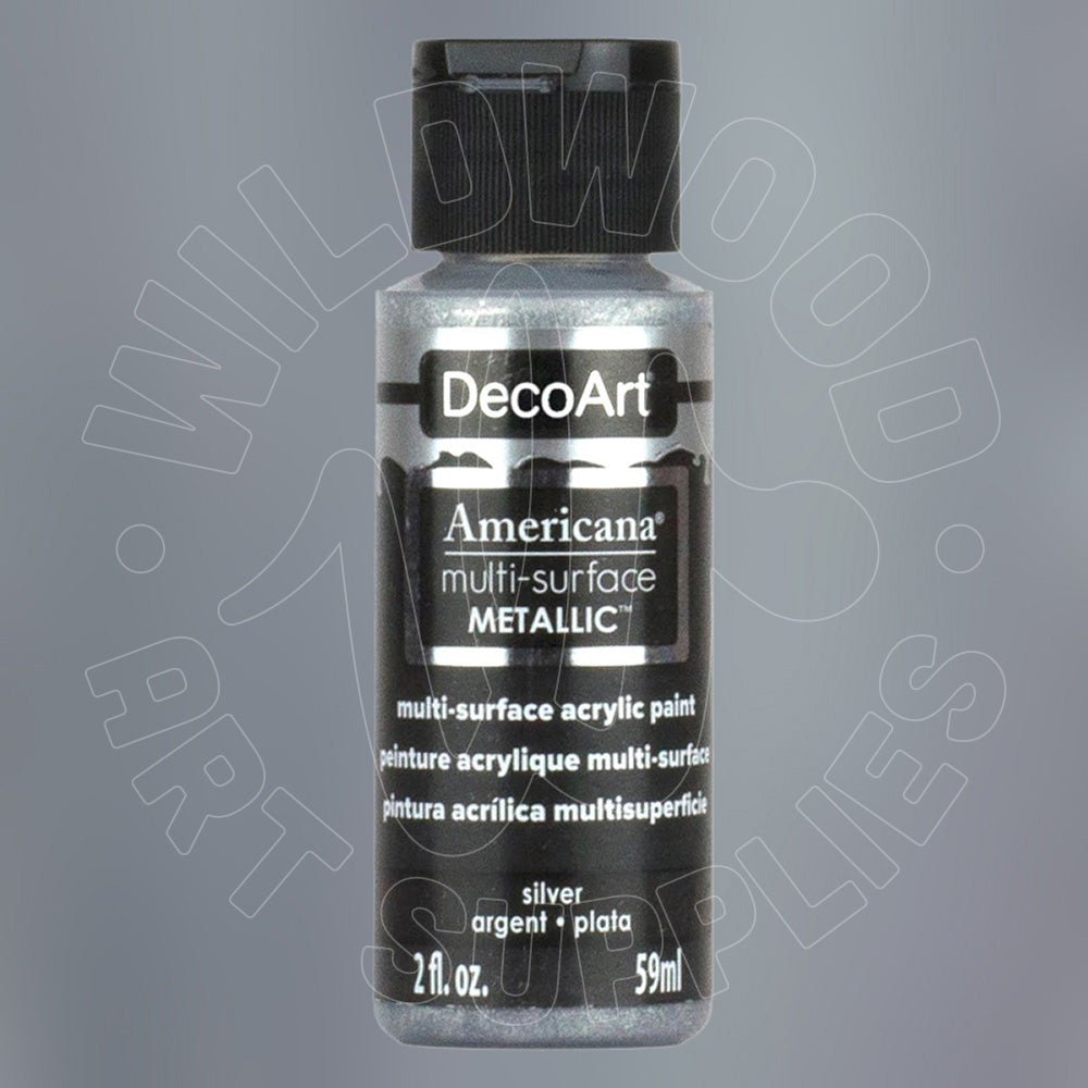 A bottle of DecoArt Americana Metallic multi-surface acrylic paint in silver, featuring a black cap and black label with white text, set against a gray background with a faint watermark.