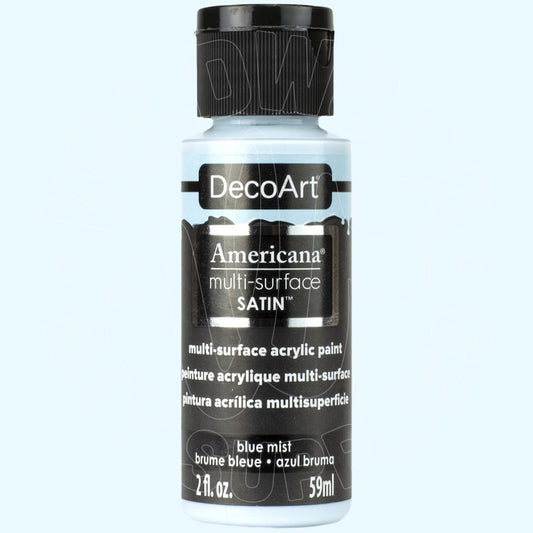 A 59ml bottle of DecoArt Americana multi-surface satin acrylic paint in the color 'blue mist', featuring a black cap and black label on a light blue background.
