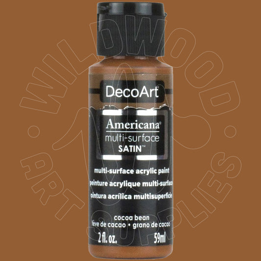 A bottle of DecoArt Americana multi-surface satin acrylic paint in the color 'cocoa bean' (brown), featuring a black cap and black label on a solid brown background.