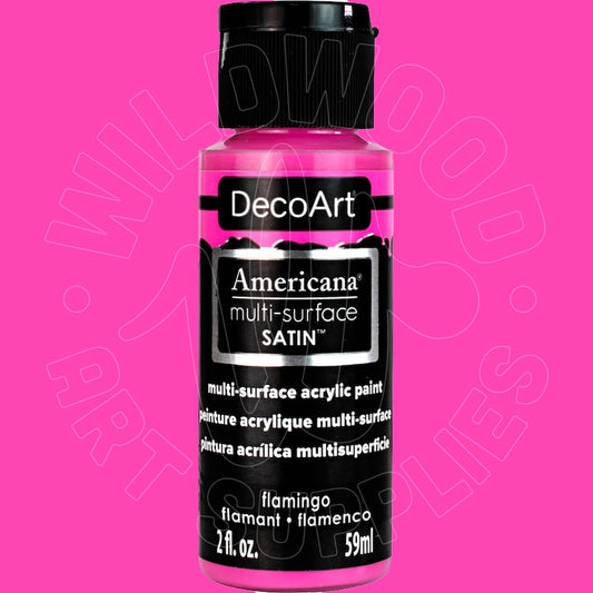 A bottle of DecoArt Americana multi-surface satin acrylic paint in the shade flamingo, featuring a black cap and black label with white text, set against a solid bright pink background.