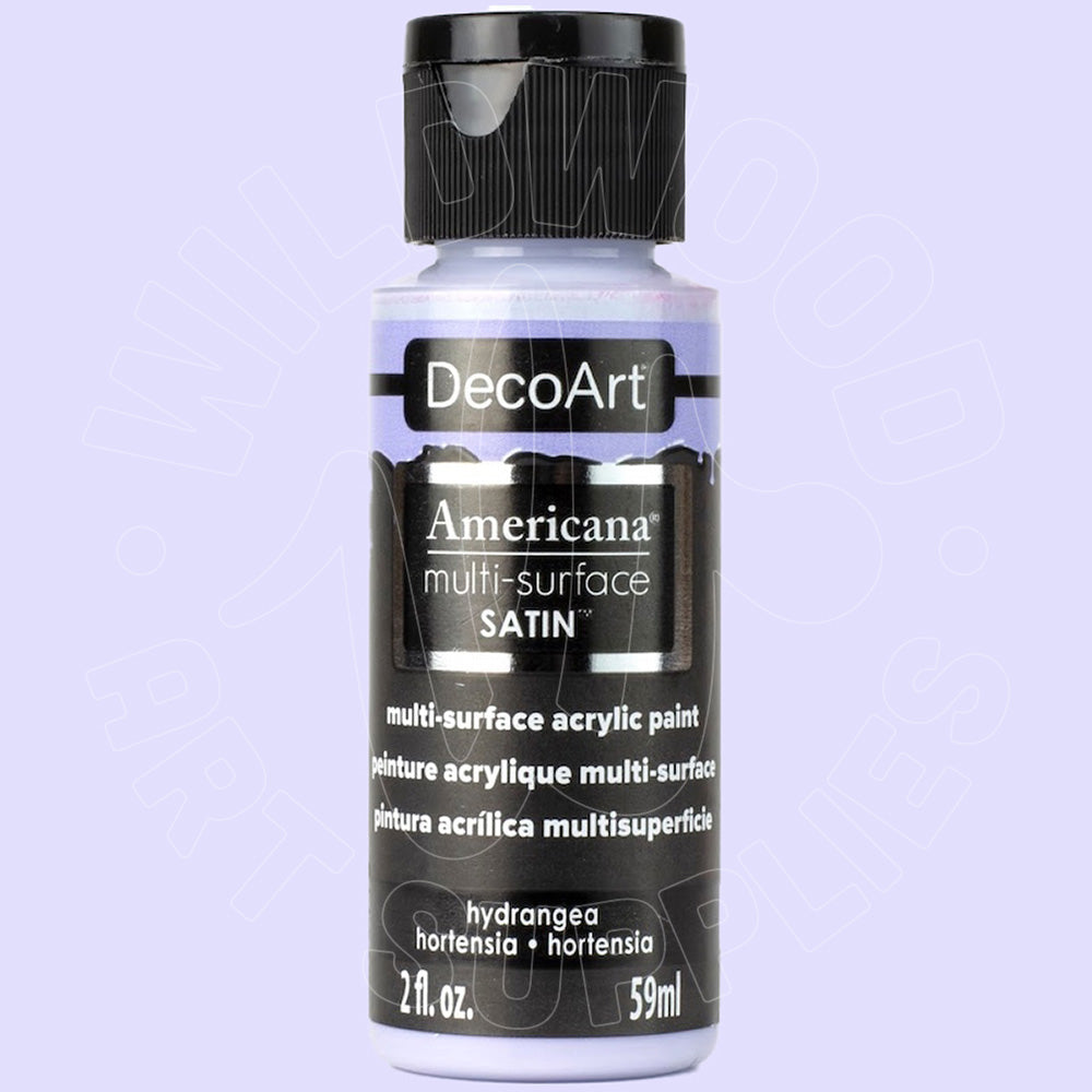 A bottle of DecoArt Americana multi-surface satin acrylic paint in the shade Hydrangea, shown against a light lavender background.