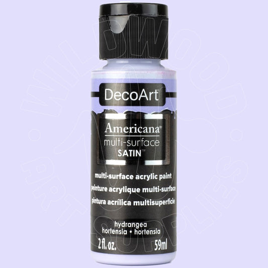 A bottle of DecoArt Americana multi-surface satin acrylic paint in the shade Hydrangea, shown against a light lavender background.