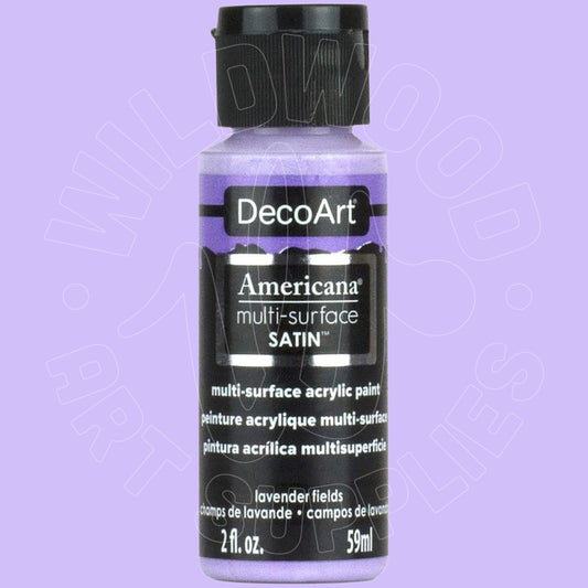 A bottle of DecoArt Americana multi-surface satin acrylic paint in the color 'lavender fields', featuring a lavender-purple label and a black cap, set against a solid lavender background.
