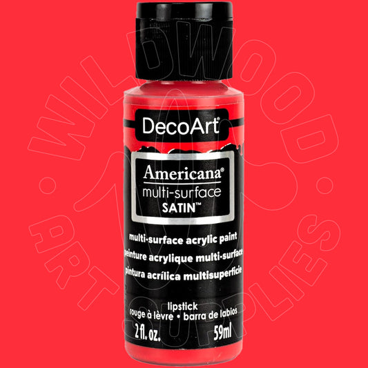 A bottle of DecoArt Americana multi-surface SATIN acrylic paint in the shade lipstick, featuring a black cap and black label with white text, set against a solid red background.