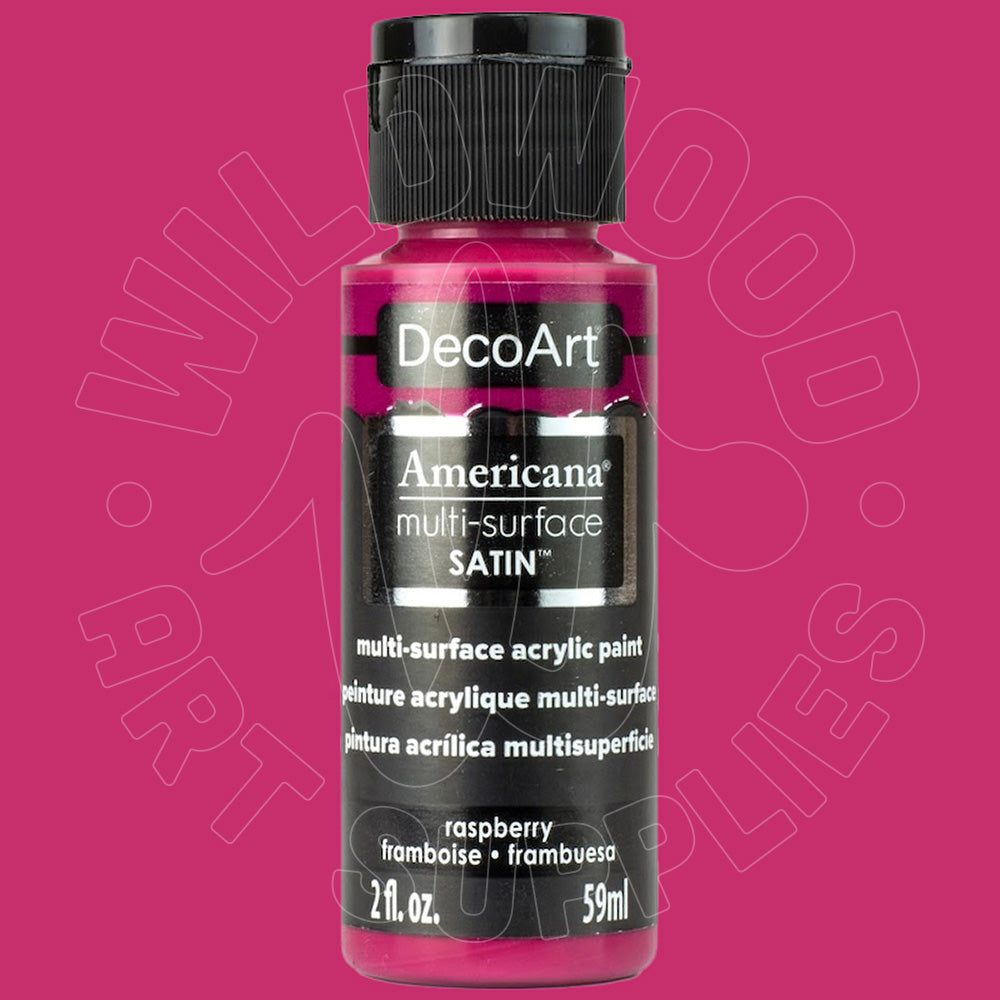 A bottle of DecoArt Americana multi-surface satin acrylic paint in raspberry, featuring a black cap and black label with white text, set against a solid magenta-pink background.